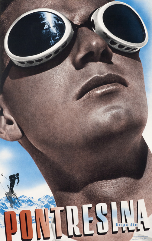 Close up view of man with ski goggles on; blue, black red, white