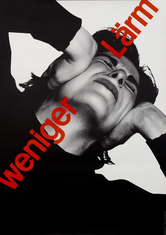 Upwardly angled photograph of man covering ears; black, grey, red