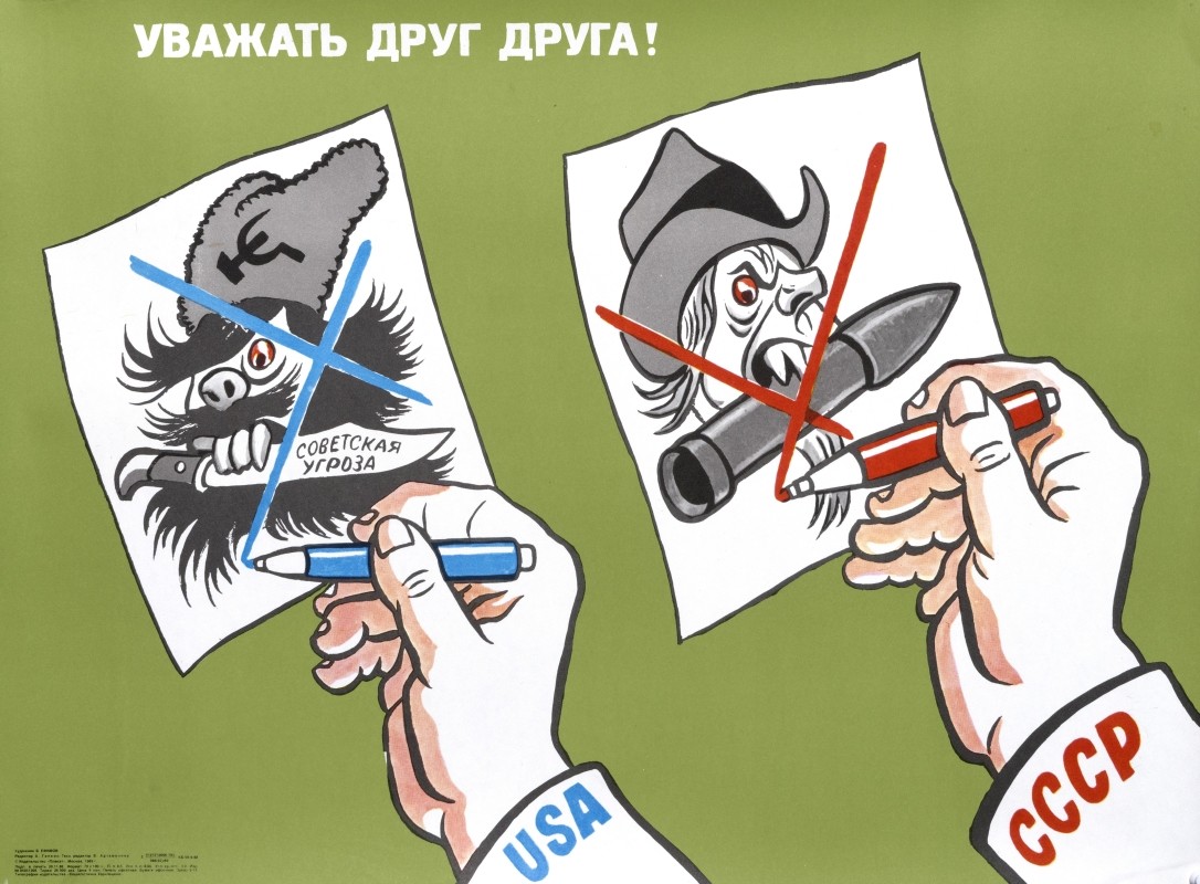 two hands holding up caricature portraits; green, white, grey