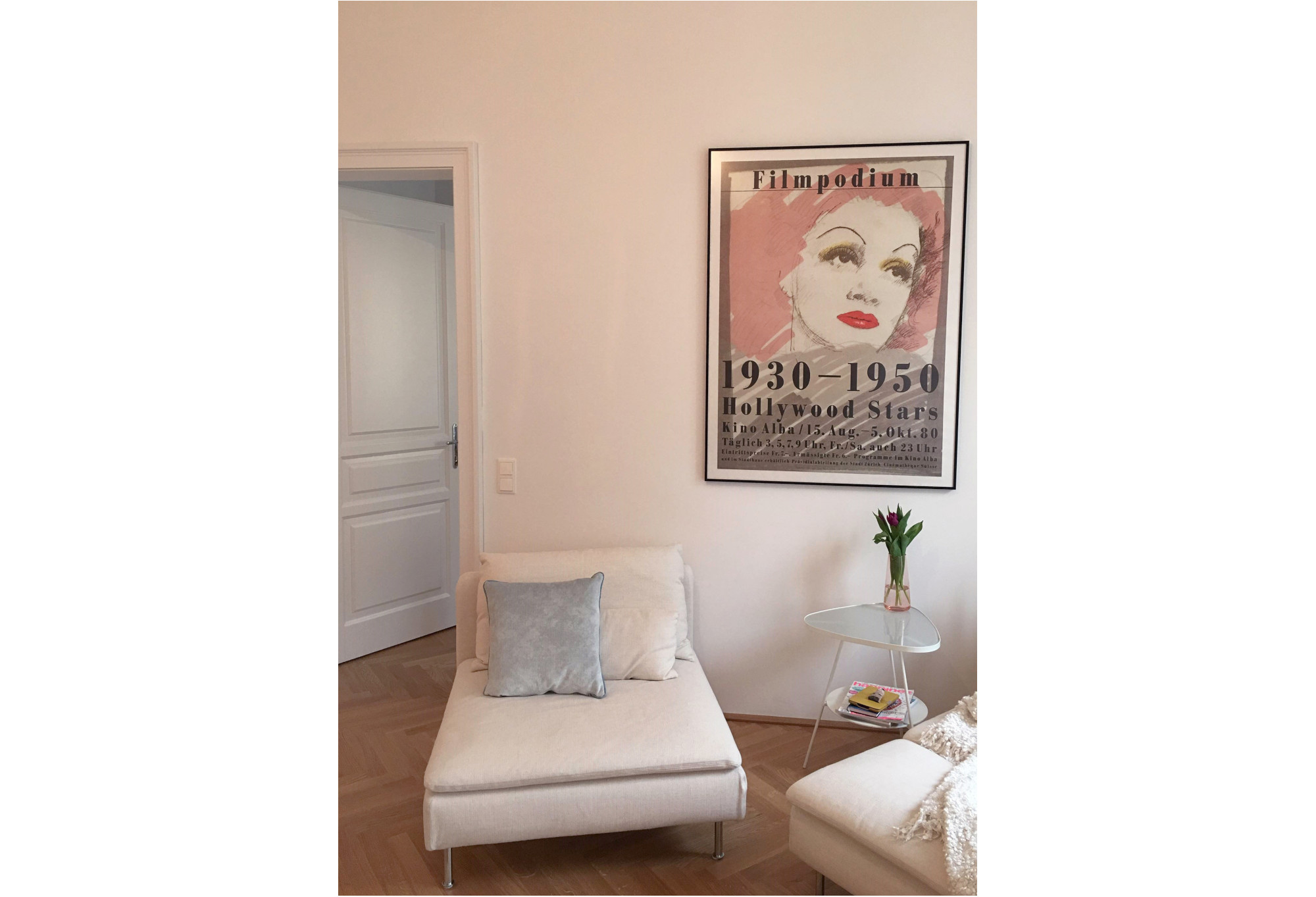 framed Hollywood starlet poster above settee; pink, white, grey, brown