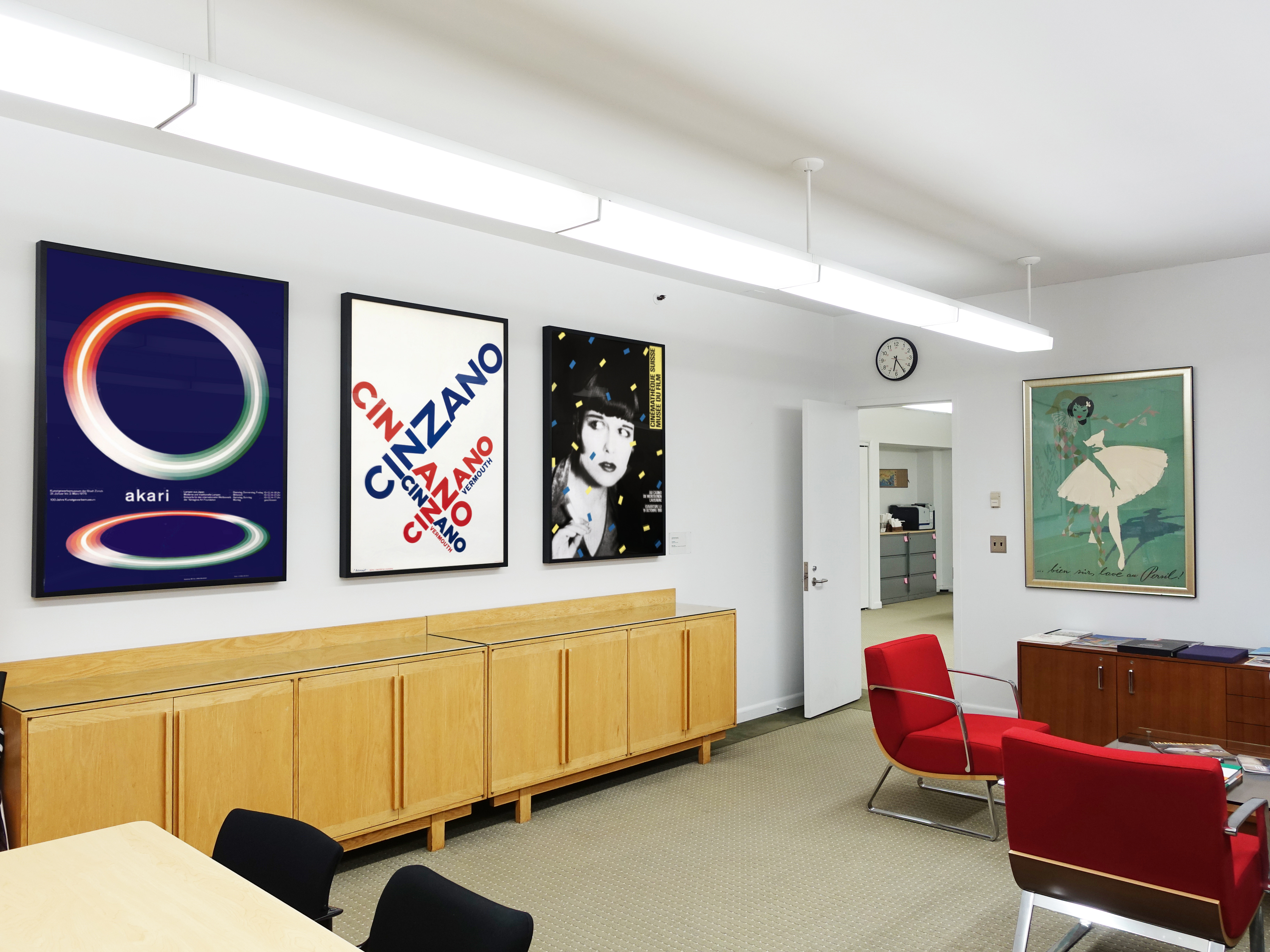 wide view of office and chairs, four posters on walls; blue, red, yellow, green